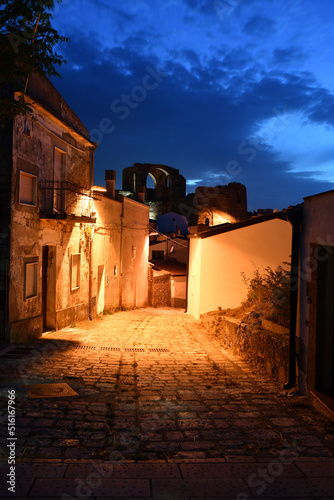A narrow street between the old houses of Grottole, a village in the Basilicata region, Italy.
