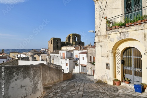 A narrow street between the old houses of Grottole, a village in the Basilicata region, Italy. © Giambattista