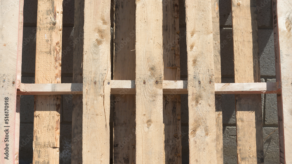 wooden pallet leaning against a wall in the sun wooden pallet leaning against a wall in the sun