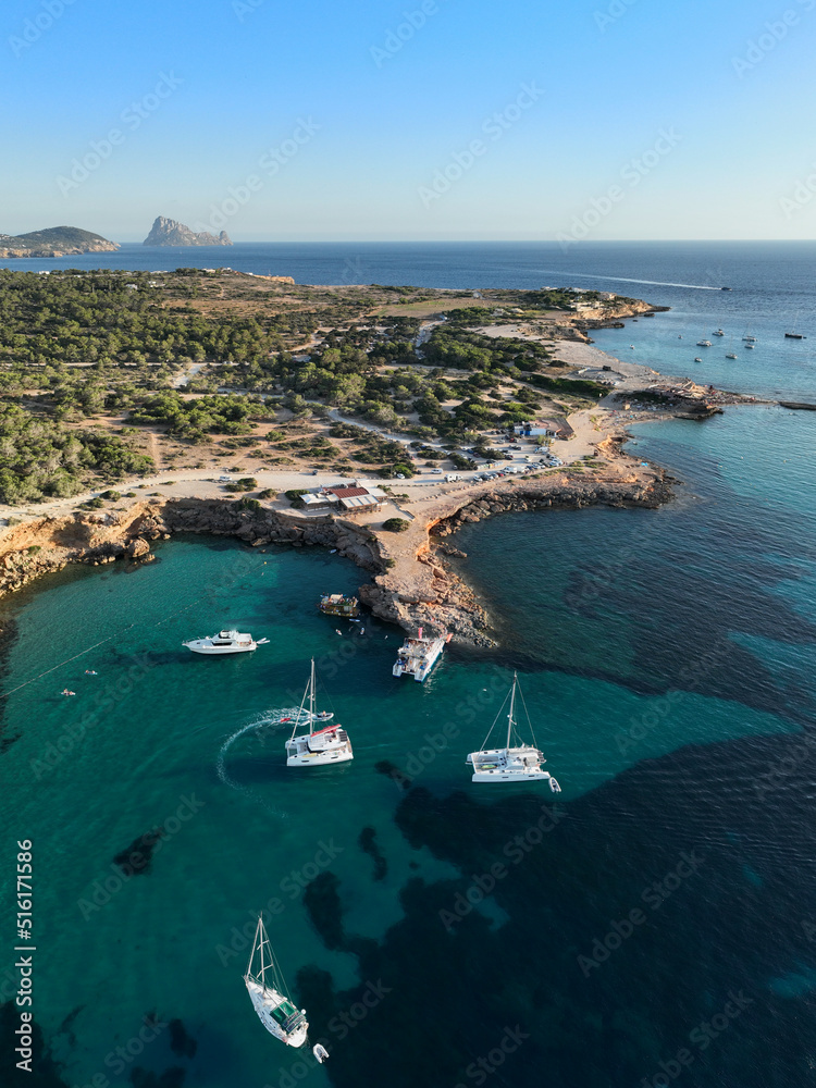 Cala Comte beach in Ibiza. The island of Es Vedra can be seen in the background.