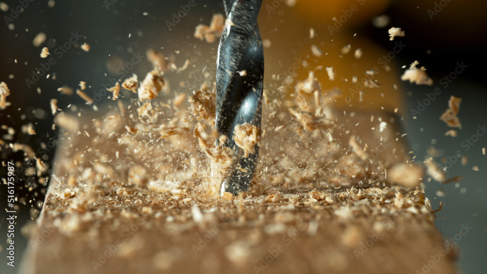 Super slow motion of a drill bit drilling into wood, macro shot