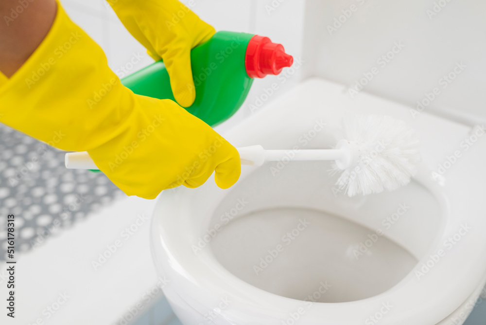 shiny, detergent, a girl in gloves cleans the ceramic toilet with a brush and disinfectant and cleanliness shiny, detergent, a girl in gloves cleans the ceramic toilet with a brush and disinfectant and cleanliness