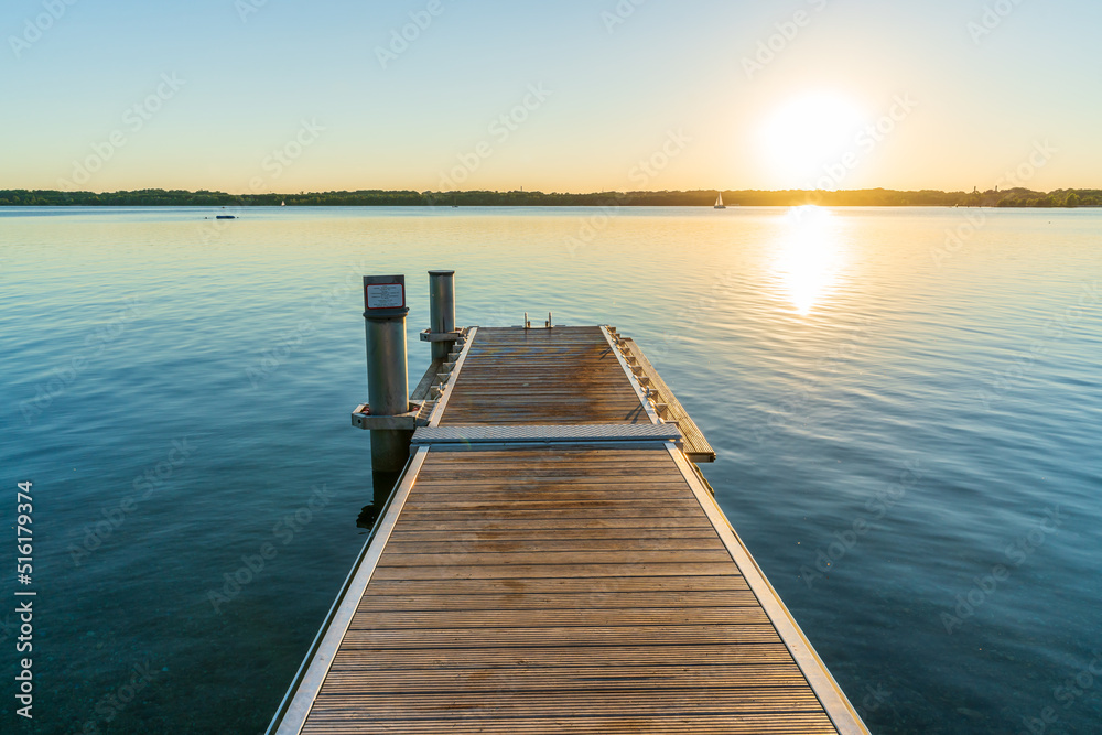 Naklejka premium A beautiful sunset behind a jetty at the Cospudener See in summer