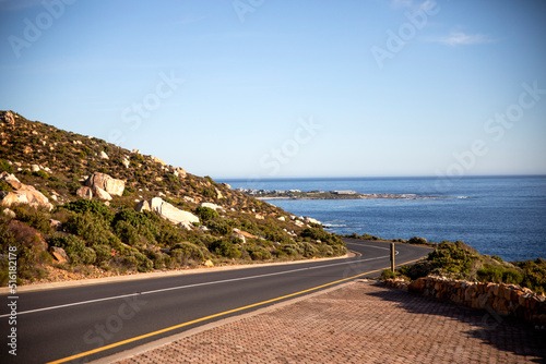 Garden route road and clarence drive with the atlantic ocean in the background this area is known as gordon bay's in South Africa is a road that runs along the coast of fynbos.
