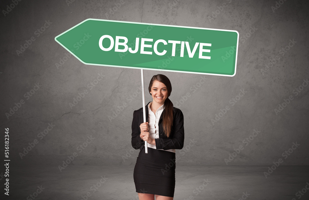 Young business person in casual holding road sign Young business person in casual holding road sign