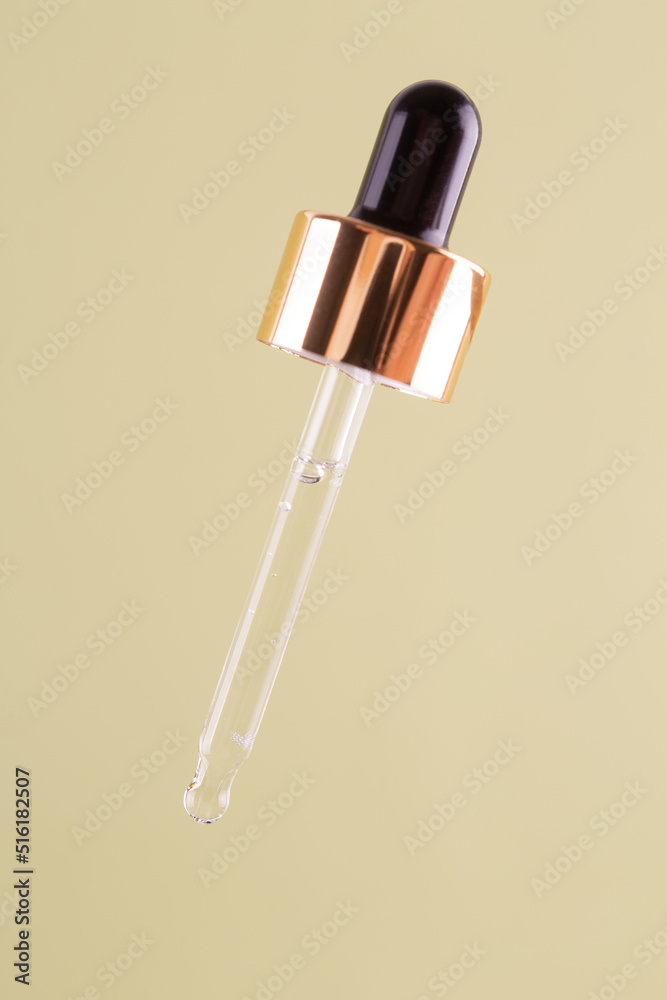 Essential clear oil or serum in pipette isolated on pastel green background close up. cosmetic pipette Essential clear oil or serum in pipette isolated on pastel green background close up. cosmetic pipette