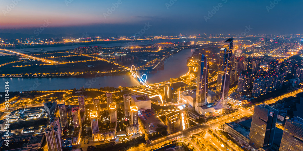 Fototapeta premium Night view of city skyline of Nanjing Eye Bridge and Poly Theater in Nanjing, Jiangsu, China
