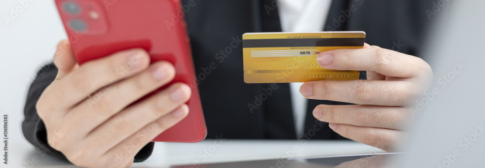 Businesswoman use mobile phones to register for security Online with a credit card to buy products online through application, Online shopping or Internet technology concept.