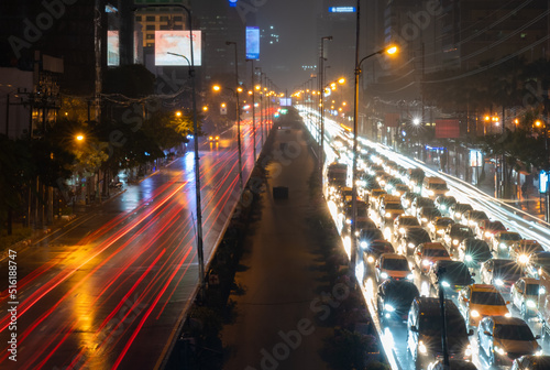Cityscape of Bangkok at Night with Traffic Jam in Rainy Day