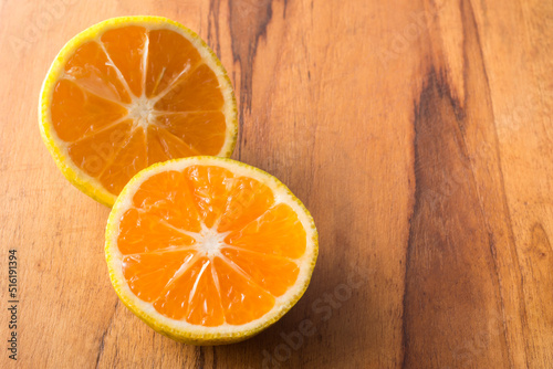 sweet orange fruit slices  isolated on a wooden surface  taken in shallow depth of field with copy space