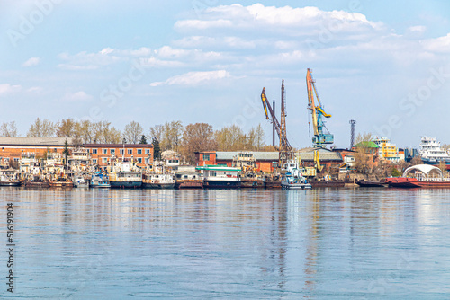 River port with moored old ships and cargo cranes © roundex