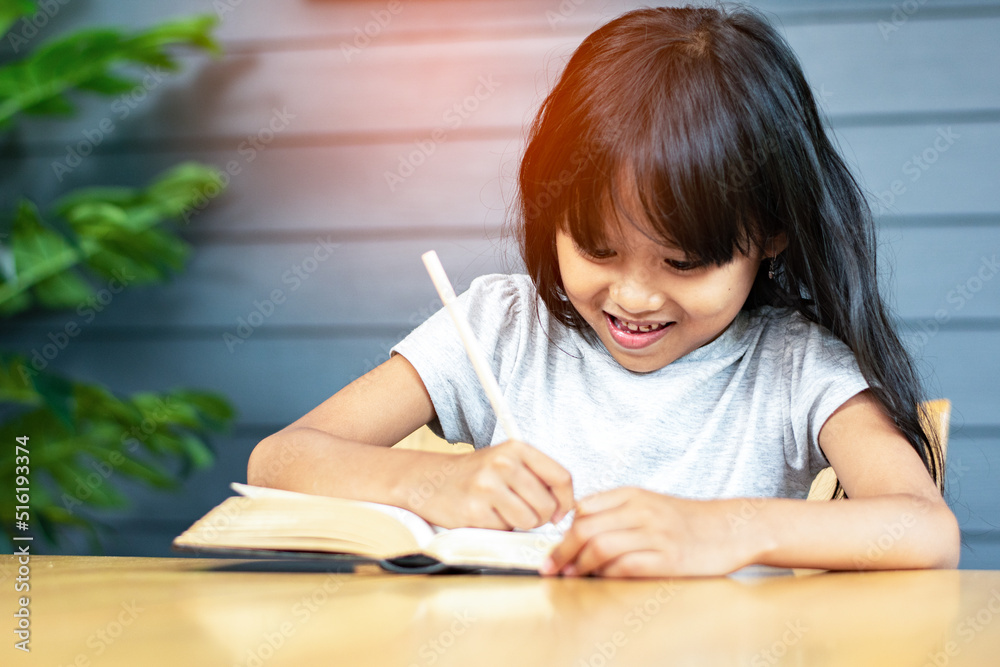 a little girl attention doing homework at home, writing a note on the book by pencil, happy girl leaning writing and reading a book on the wood table, cheerful daughter, cute girl studying, a little girl attention doing homework at home, writing a note on the book by pencil, happy girl leaning writing and reading a book on the wood table, cheerful daughter, cute girl studying,