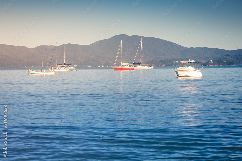 Bay with boats and sailboats in Jurere beach at sunset Florianopolis, Brazil
