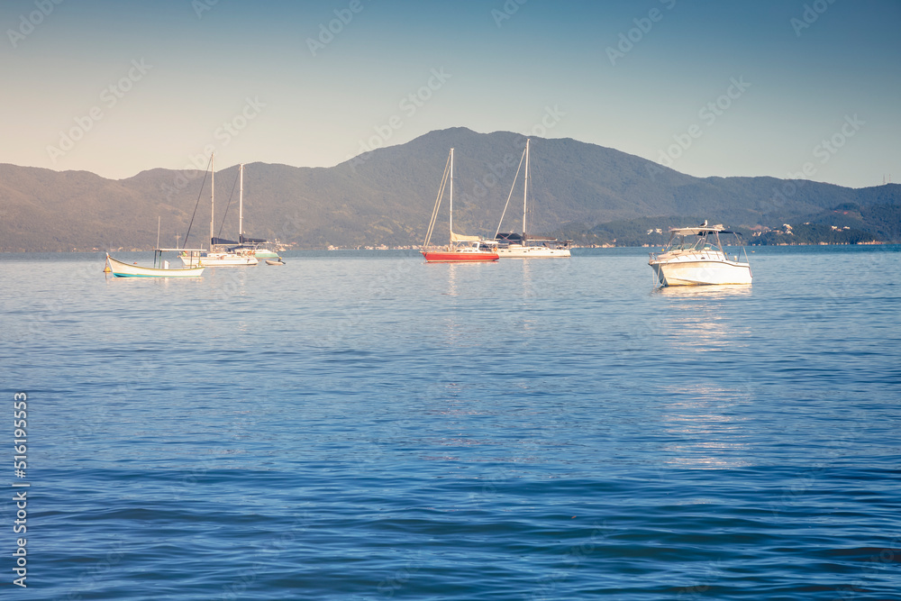 Bay with boats and sailboats in Jurere beach at sunset Florianopolis, Brazil Bay with boats and sailboats in Jurere beach at sunset Florianopolis, Brazil