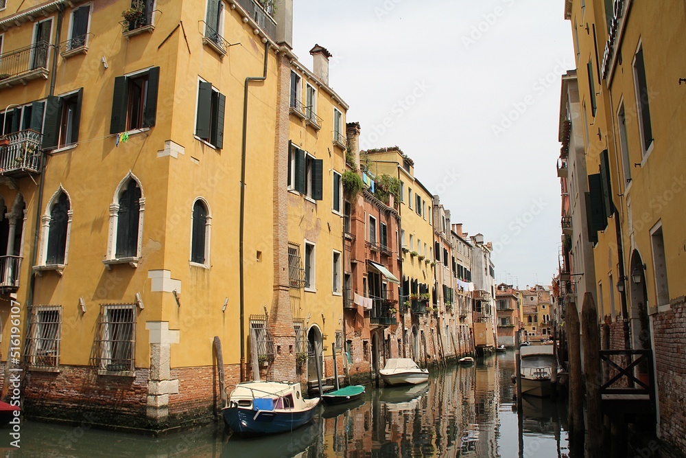 Venetian street, Venice waterway, classical buildings, Venetian architecture, moored boats, shutters, flowers in windows, Italy
