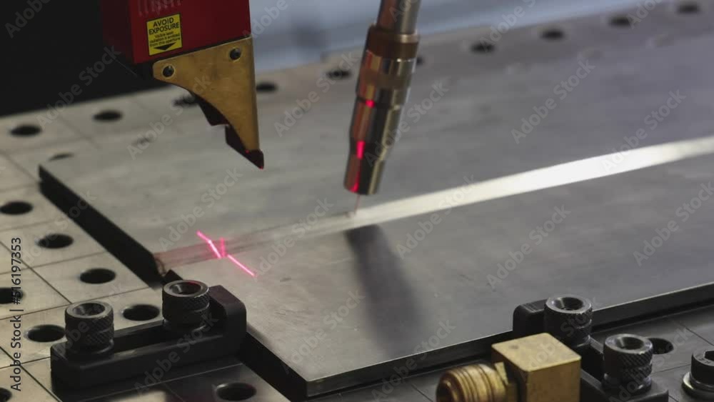 Automated Welding Robot Process With Red Laser Beam Navigation at Work Table