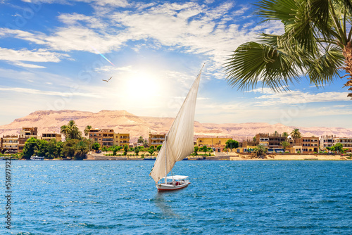 View of the Nile and a sailboat by the Valley of Kings in Luxor, Egypt