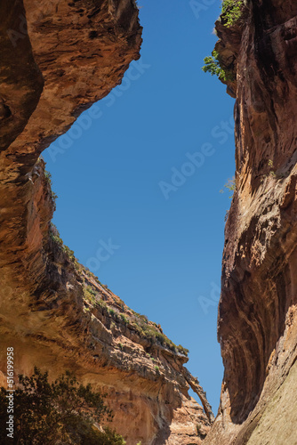 Looking up at a window of blue sky between overhanging cliff walls on the Echo Ravine Hike in Golden Gate Highlands National Park near Clarens, South Africa