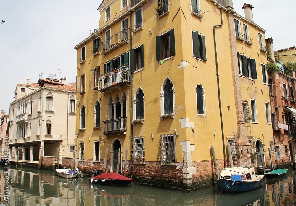 Venetian street, Venice waterway, classical buildings, Venetian architecture, moored boats, shutters, flowers in windows, Italy