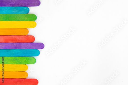 Top view of colorful ice cream sticks on white background