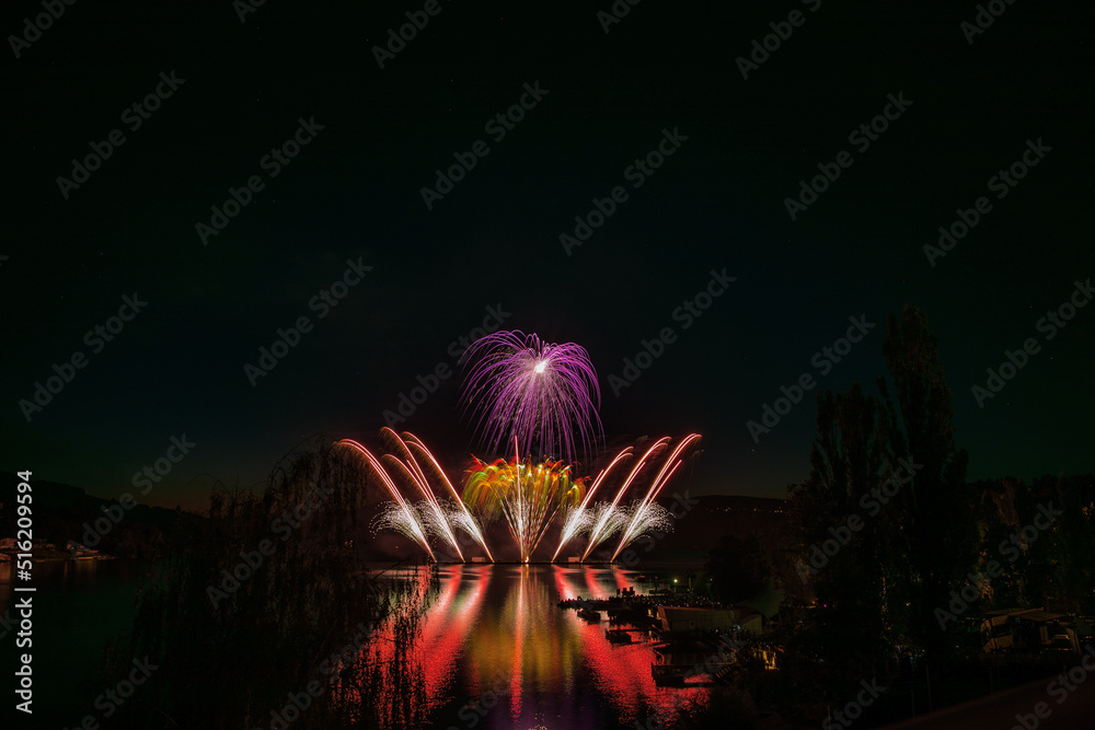 Fototapeta premium Fireworks above the water surface