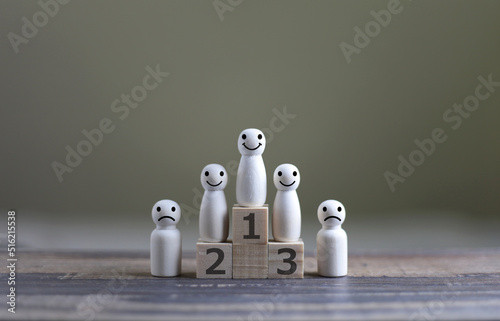 Business hierarchy; ranking and strategy concept with wood doll standing on a podium 1, 2, 3 of wooden building blocks with copy space.