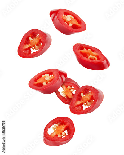 Falling sliced red hot chilli peppers isolated on white background, clipping path
