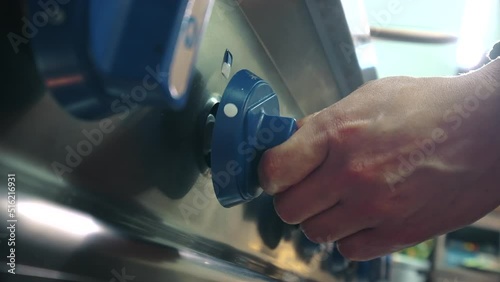 Unrecognizable chef male hands turns on gas stove in the restaurant kitchen, close up view. Cooking, professional kitchen appliances store advertisement concept
