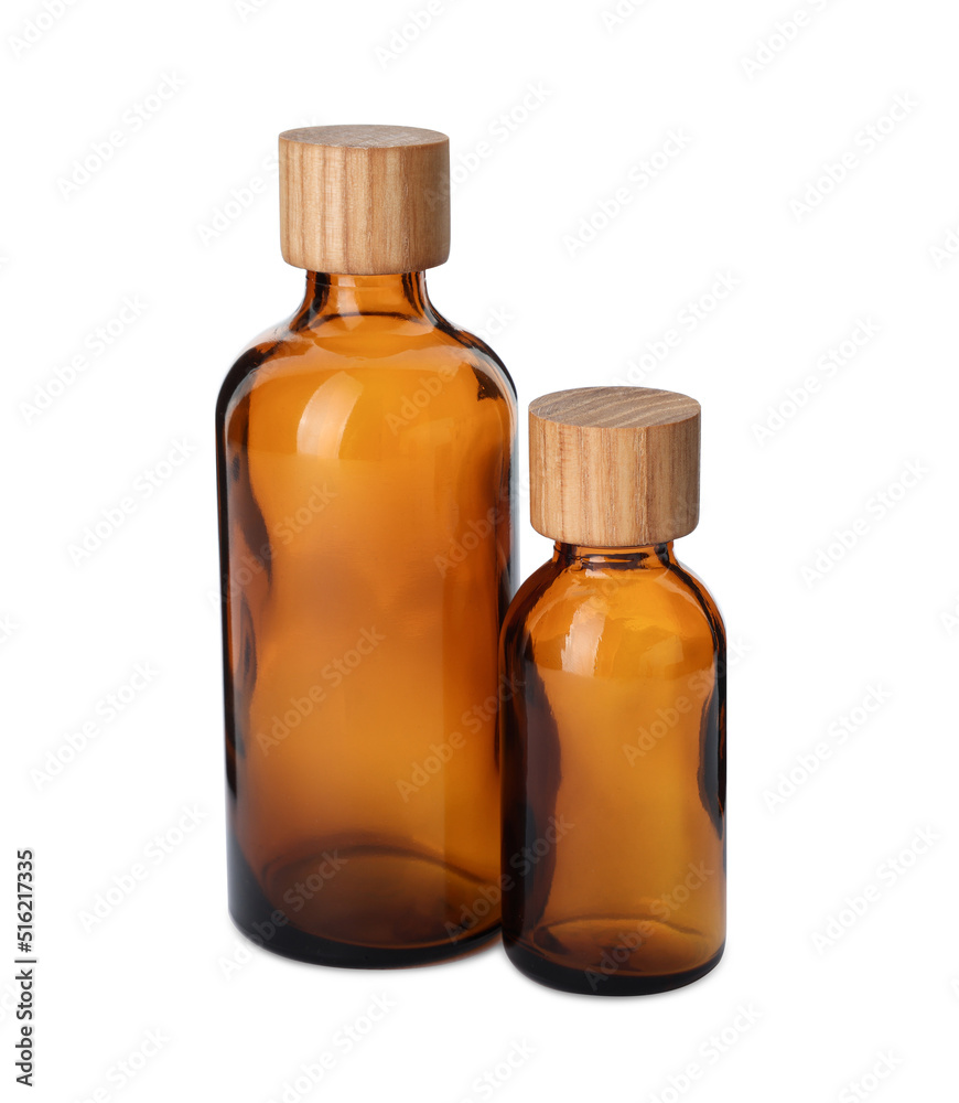 New empty glass bottles with wooden caps isolated on white