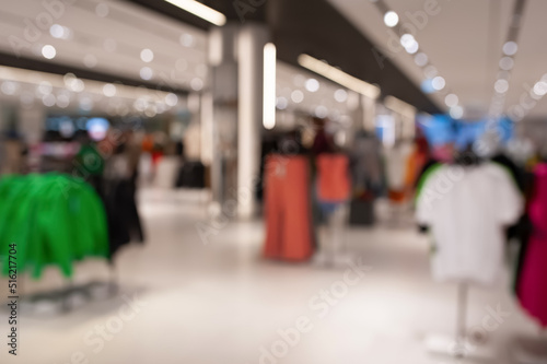 Blurred view of modern boutique interior with stylish clothes