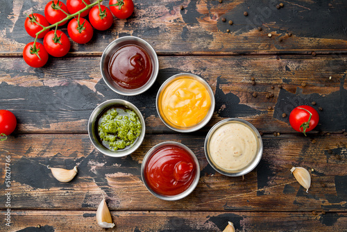 assorted sauces top view on old dark wooden table photo