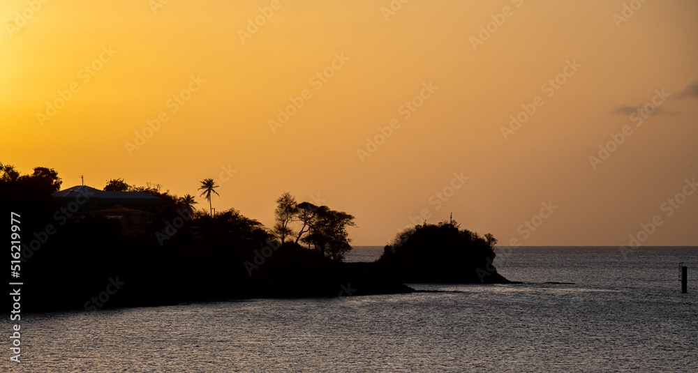 The sun setting behind the island of St Lucia