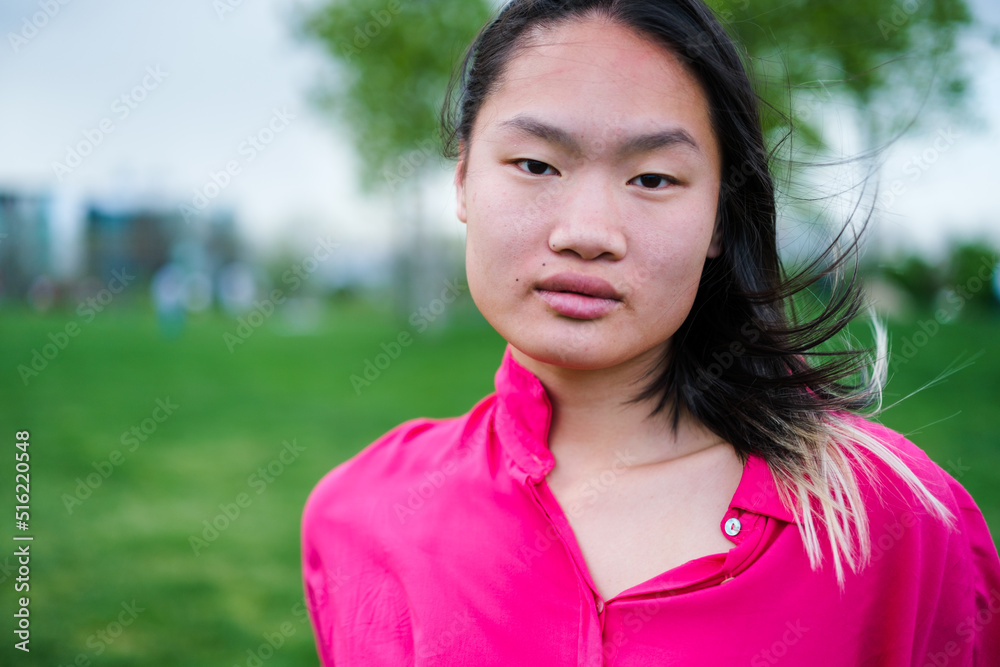 Lifestyle portrait of a young woman with oriental features in the park Lifestyle portrait of a young woman with oriental features in the park