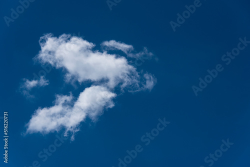 fluffy stratocumulus clouds at deep blue sky photo