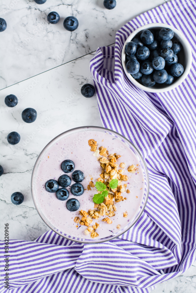 Smoothies with blueberries and granola in a bowl. Organic antioxidant healthy food. Top and vertical Smoothies with blueberries and granola in a bowl. Organic antioxidant healthy food. Top and vertical
