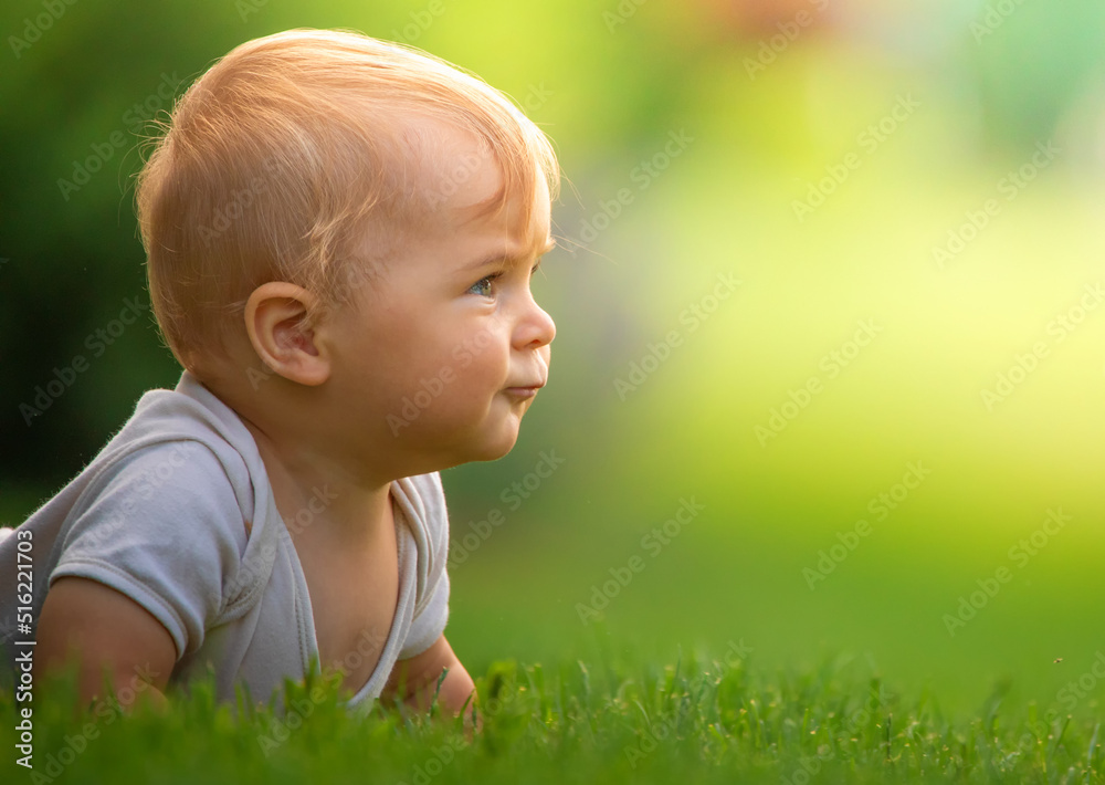 Little happy baby on green grass. selective focus Little happy baby on green grass. selective focus