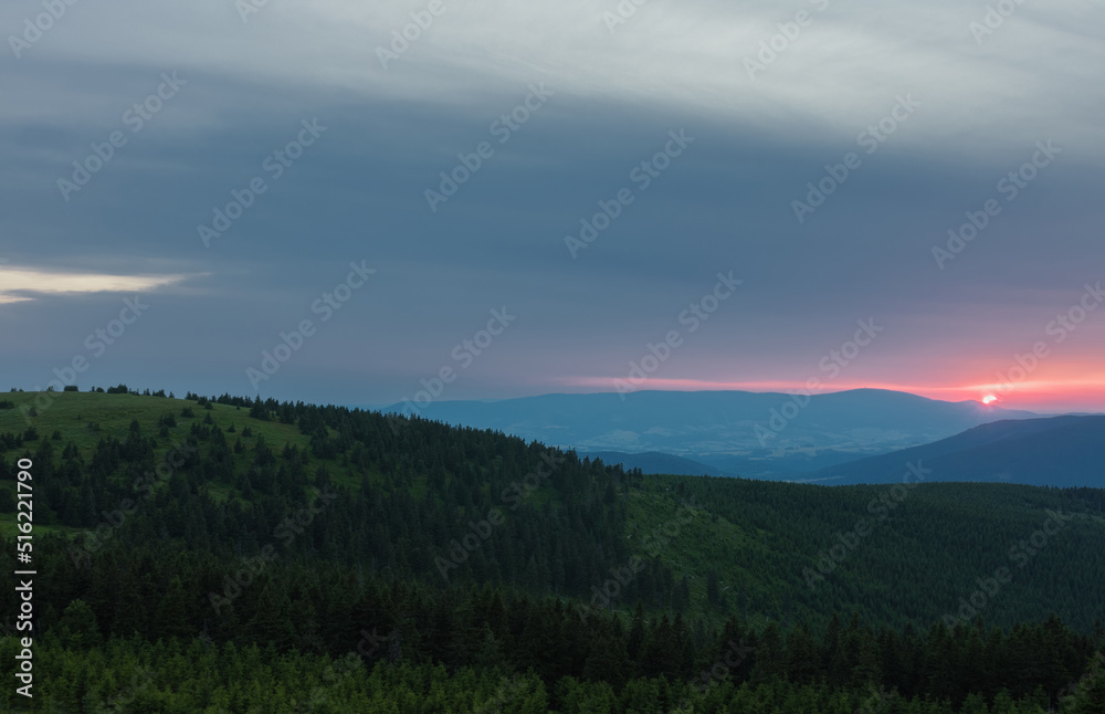 Mravenecnik hill , view from upper water reservoir of the pumped storage hydro power plant Dlouhe Strane in Jeseniky Mountains, Czech Republic.During summer evening, sunset.