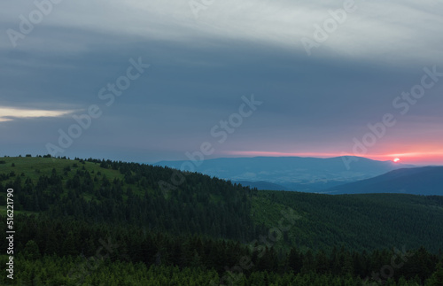 Mravenecnik hill , view from upper water reservoir of the pumped storage hydro power plant Dlouhe Strane in Jeseniky Mountains, Czech Republic.During summer evening, sunset.