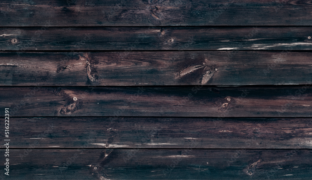 Fototapeta premium Old Weathered Natural Log Cabin Aged Wall Facade Texture. Rustic Log Wall Horizontal Brown Background. Aged Wall Fragment Of Unpainted Brown Wooden Debarked Logs. Old Barn Wall Wood Wallpaper.