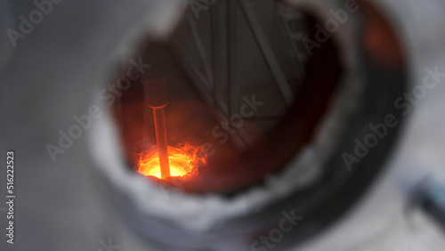 Close up of small window inside metal barrier for observing melting process, modern technologies concept. Stock footage. Melting furnace during working process.
