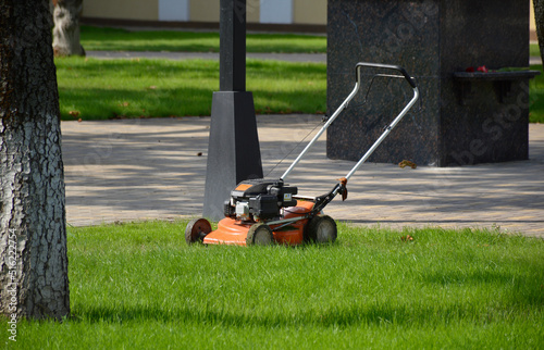 Obraz na plátně lawn mower stands on green grass