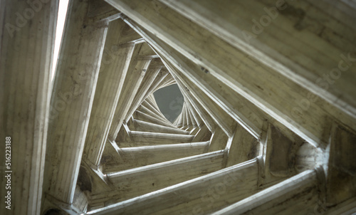 Endless tunnel optical illusion, multiple triangles in torsion effect. Inside view of the clock tower located in the Rectorate Square at Central University of Venezuela UCV Caracas - Venezuela photo