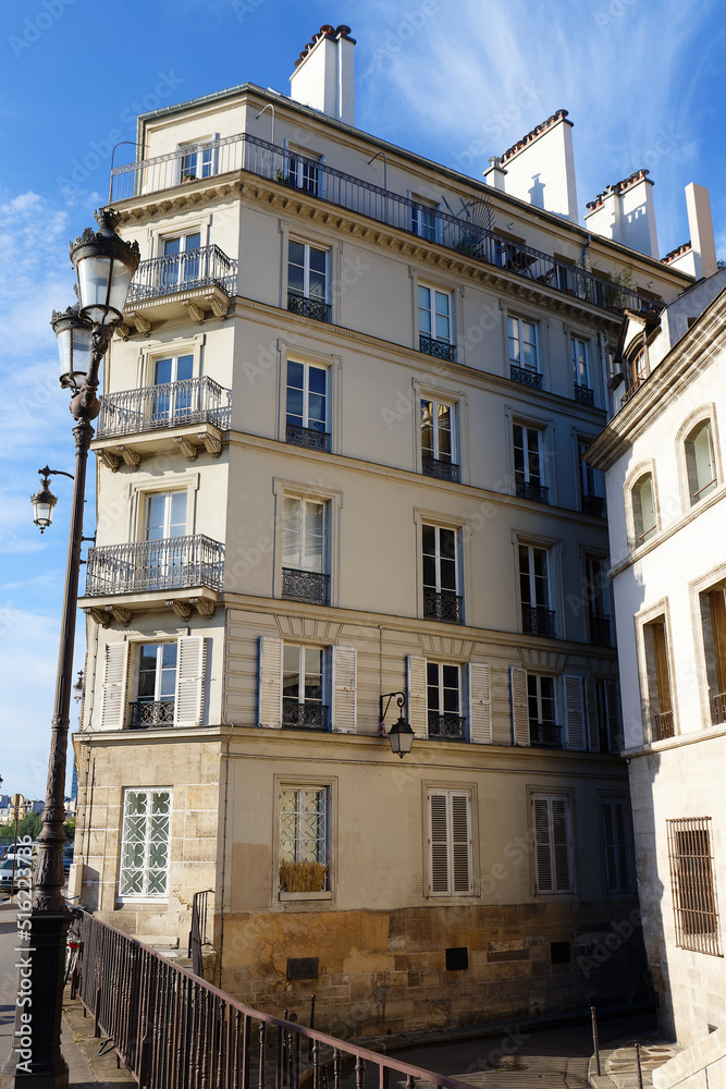 Fototapeta premium The facades of traditional French houses with typical balconies and windows. Paris.