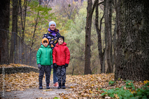 Mother and her children boys are playing together on autumn walk © pahis