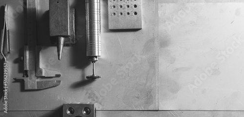 Equipment and tools of a goldsmith on metal background. Copyspace