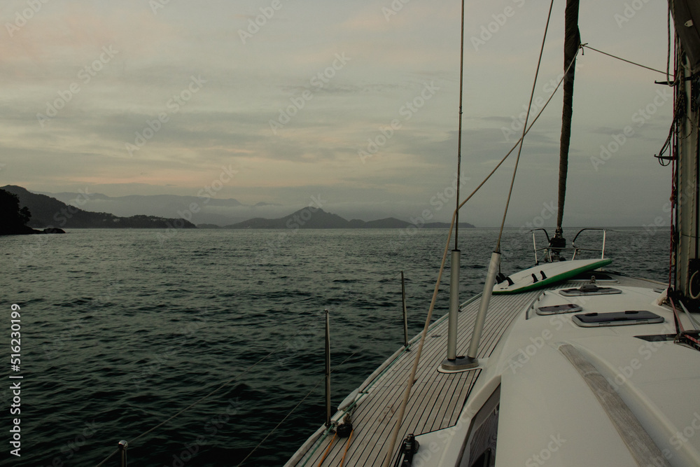 View from a sailboat deck looking towards the bow on a sunny day