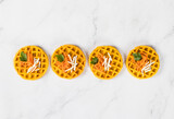 Appetizer round carrot waffles. Light background. Top view