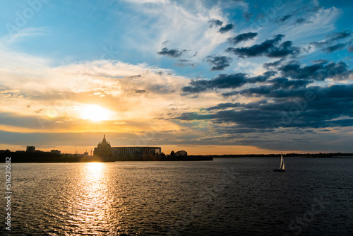 Dramatic colorful golden susnet sky with clouds over the Volga river - sun goes down, evening time, warm light. Calm, peaceful, atmospheric view, relaxation concept