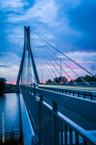 Signature bridge at the astonishing blue-pink colour, rainy evening. Long exposure gives the picture the motion of the cars and lights. 