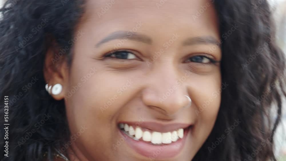 Close up portrait of a young smiling attractive African Latin American woman. Empowered woman, positive emotions